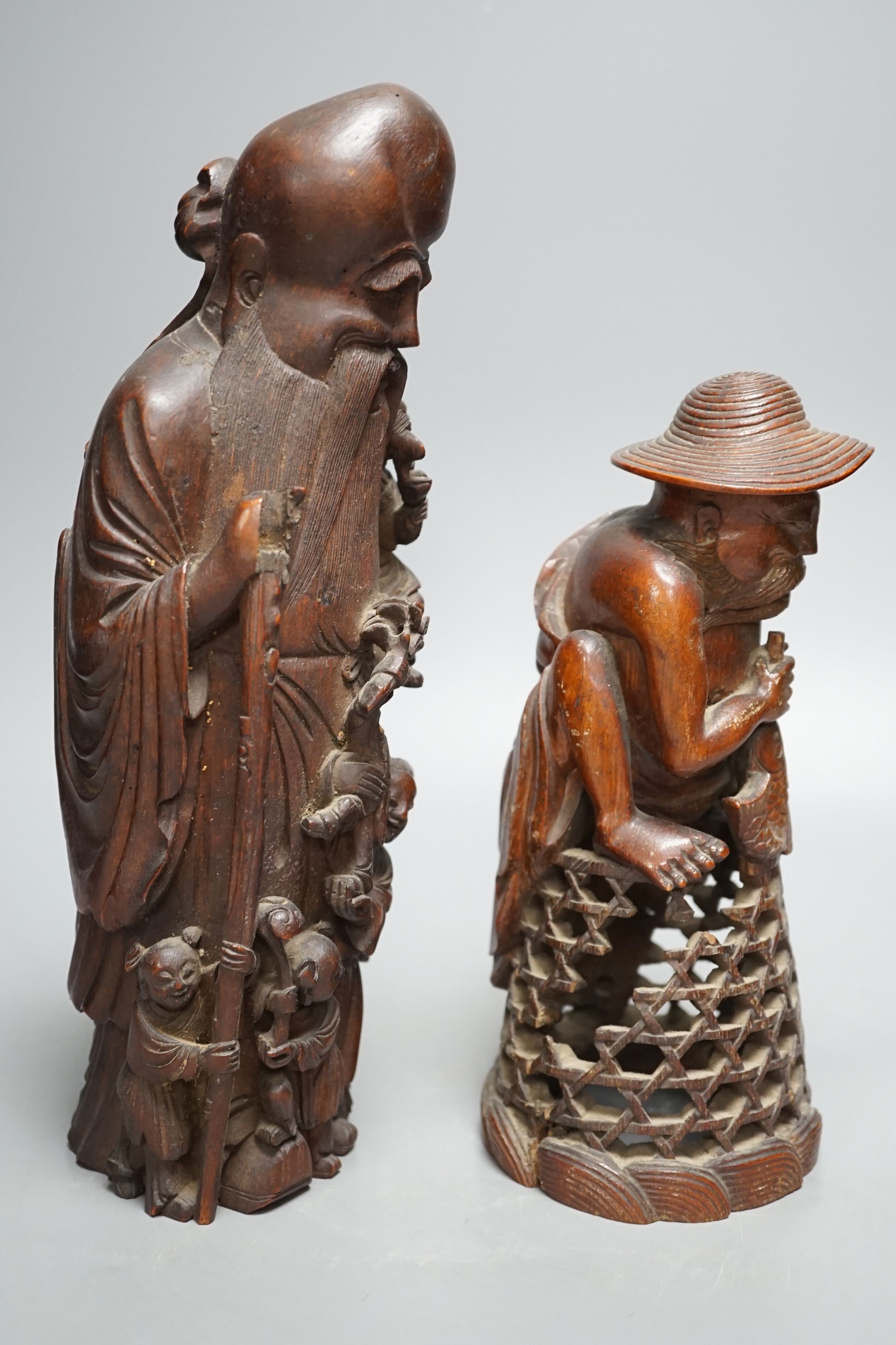 A 19th century Chinese bamboo figure of Shou Lao and a similar bamboo carving of a fisherman, 32 and 25cm, some losses